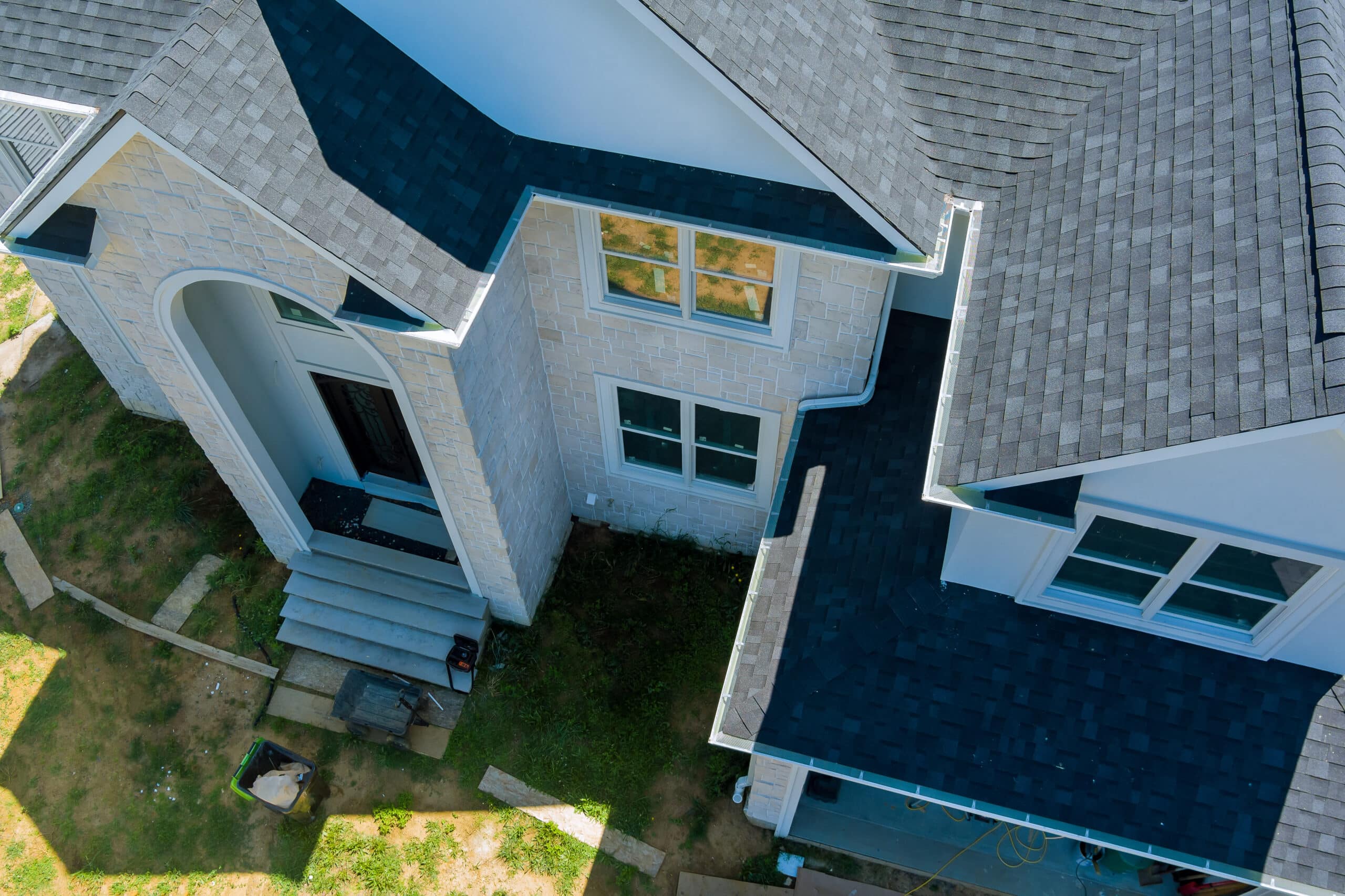 Aerial view of asphalt shingles roofing construction, the house with new window Aerial view