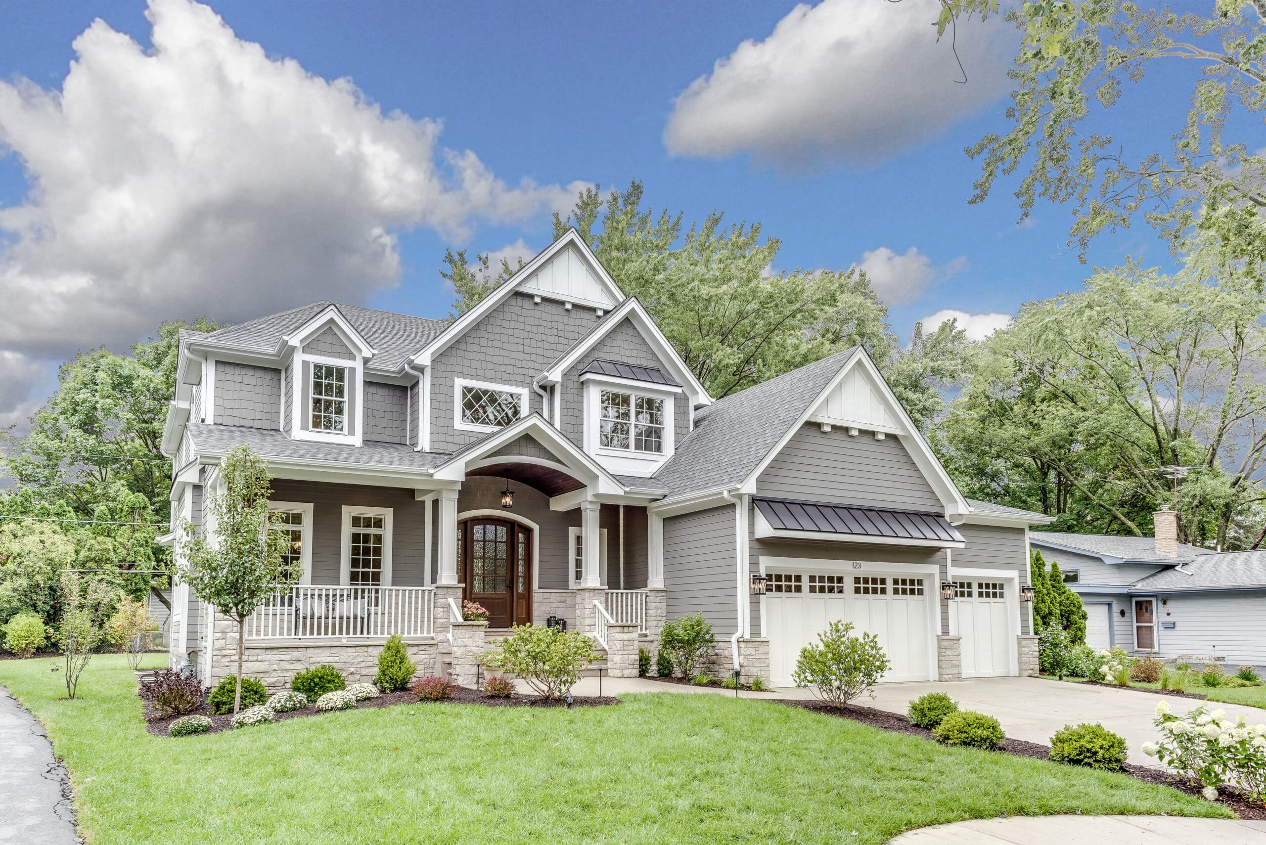 Craftsman style home with shake siding and stunning front porch Craftsman style home