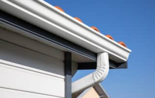 Roof showing gutters aluminum and soffit on the back of wooden house