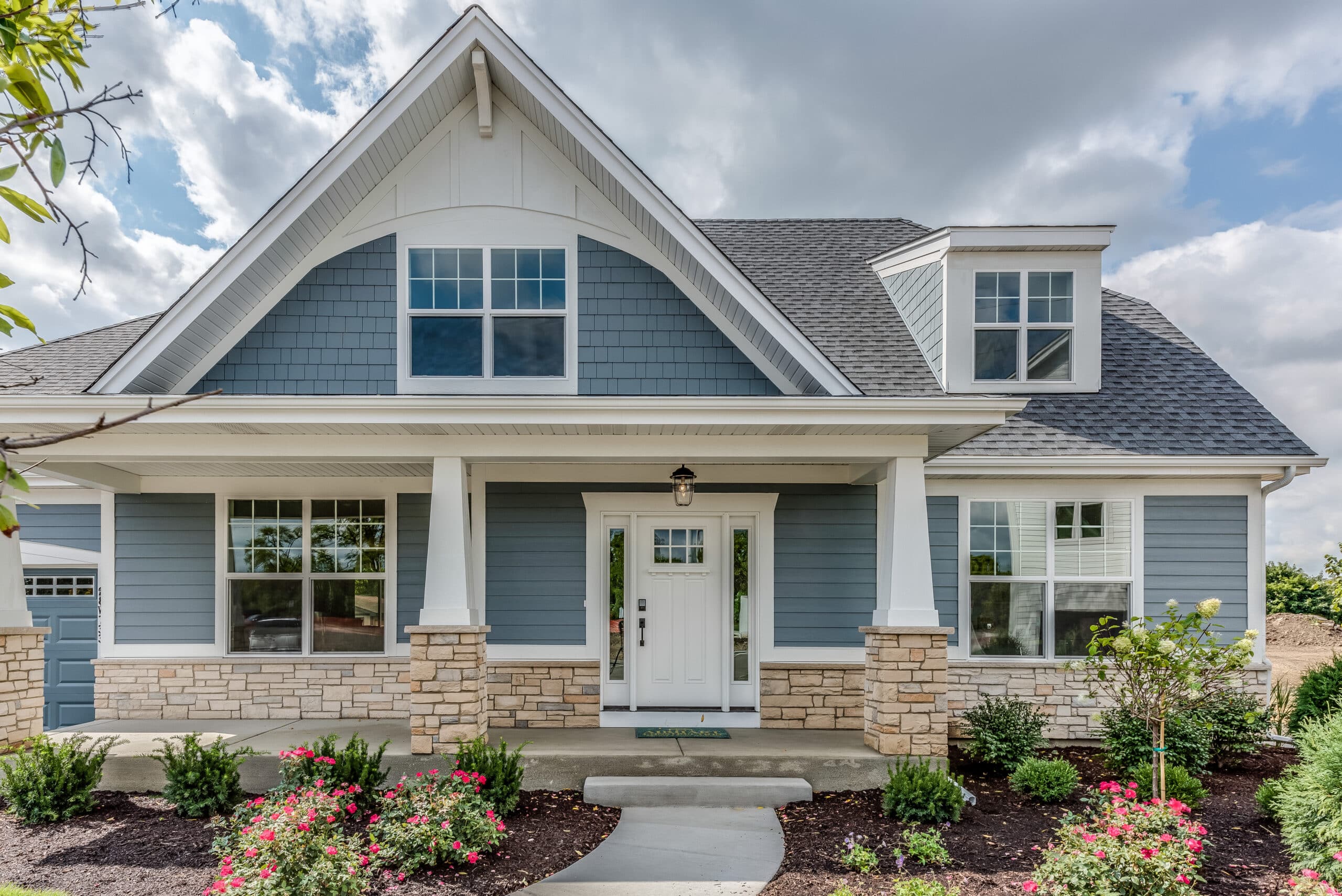 Blue front exterior of newly built home fully landscaped Blue front exterior of newly built home fully landscaped