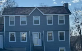 Professionals installing vinyl siding on a residential home in East Granby Connecticut