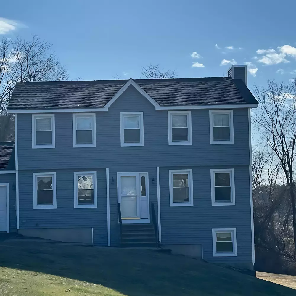 Professionals installing vinyl siding on a residential home in East Granby Connecticut