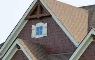 Peter L Brown team installing shake vinyl siding and Atlas roof shingles on a residential home for durable and attractive exterior upgrades