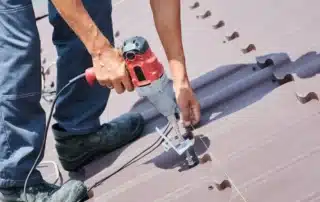 Vinyl siding contractors and Atlas roofing professionals working on a Connecticut home exterior for durable and high-quality installation