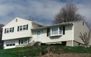 Damaged vinyl siding being replaced to protect a home exterior