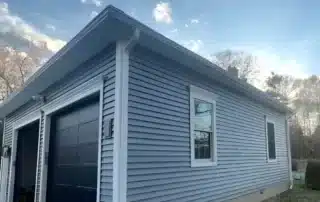 Properly installed gutter guards directing water away from a home to prevent overflow and basement flooding