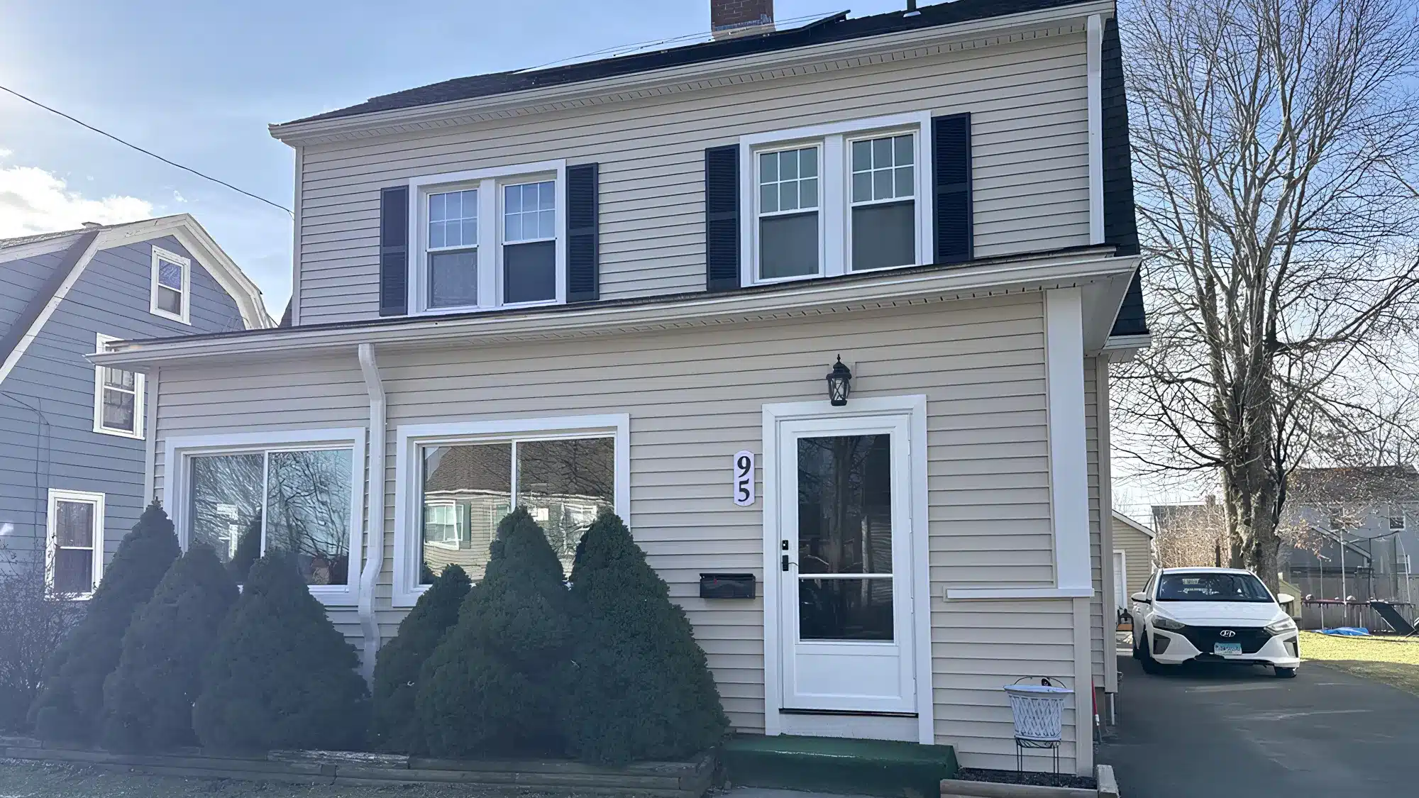 Window replacement contractor installing vinyl replacement windows for energy efficiency, home improvement, and exterior remodeling project