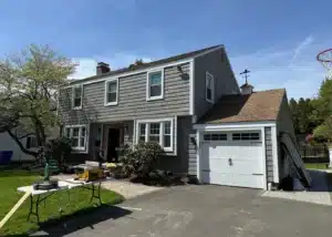 Completed exterior renovation project in West Hartford CT featuring vinyl siding, vinyl shake, ProVia entry door, and aluminum trim installation by Peter L Brown Roofing Contractors showcasing a finished residential home upgrade