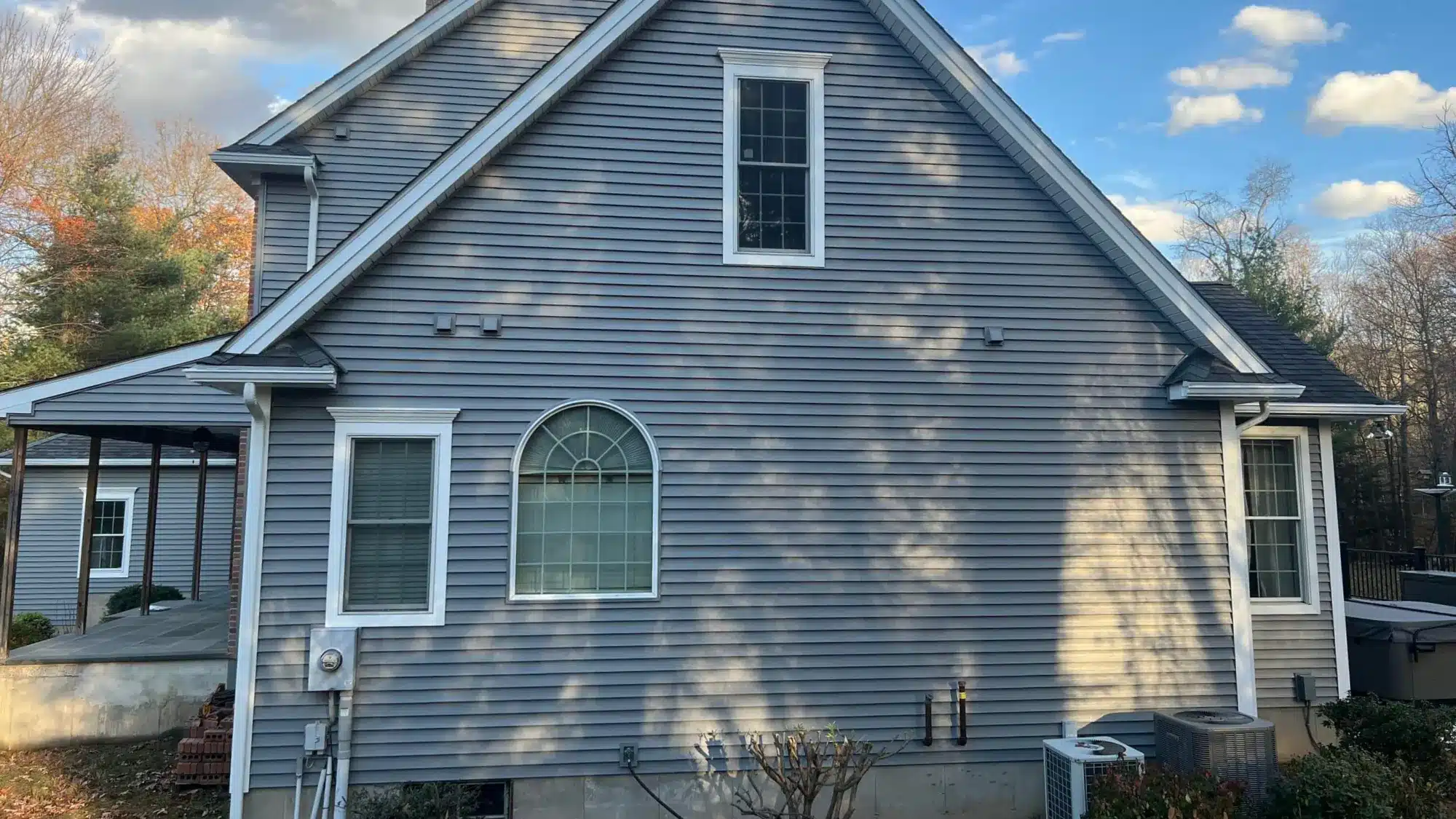 how-to-choose-the-most-effective-gutter-guards-for-connecticut-s-challenging-weather-conditions A house with clean and secure gutters in a snowy landscape
