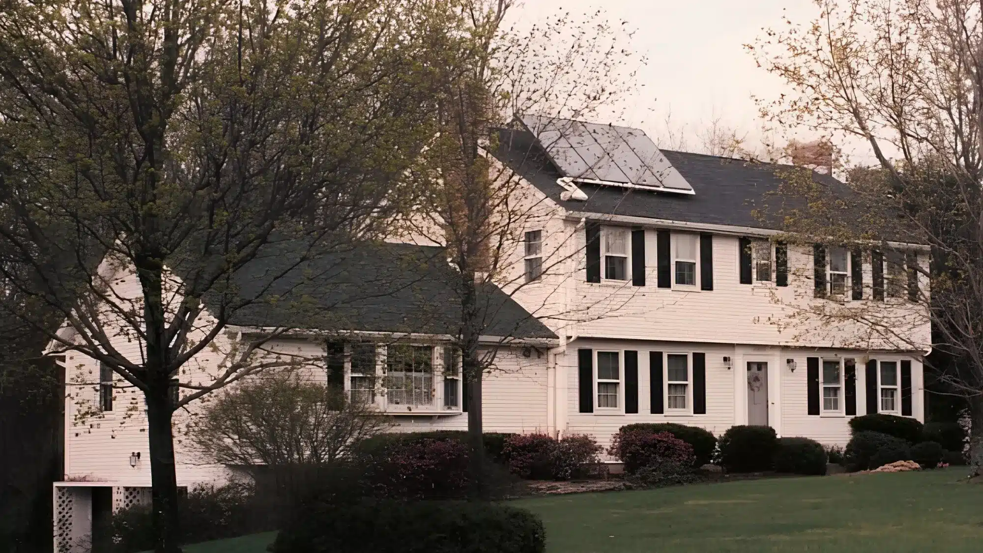 hiring-a-vinyl-siding-company-starts-with-asking-these-smart-and-important-questions-first A homeowner discusses vinyl siding options with a contractor outside a beautifully updated house.